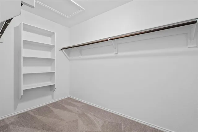 a en suite bathroom with a double vanity sink and a mirror