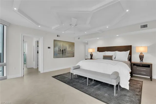 a bedroom with a bed a couch and dresser