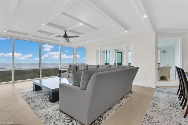 a living room with furniture and a floor to ceiling window