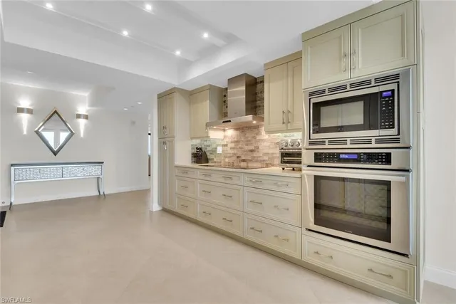 a kitchen with cabinets and chairs