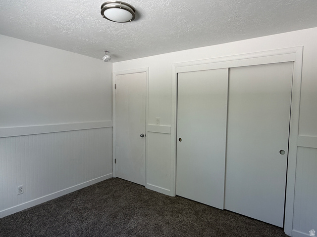 375 East 10560 South Sandy, UT 84070 - Photo 8 of 21 Interior space featuring plush carpeting, wainscoting detailing, and a flush-mount ceiling light fixture
