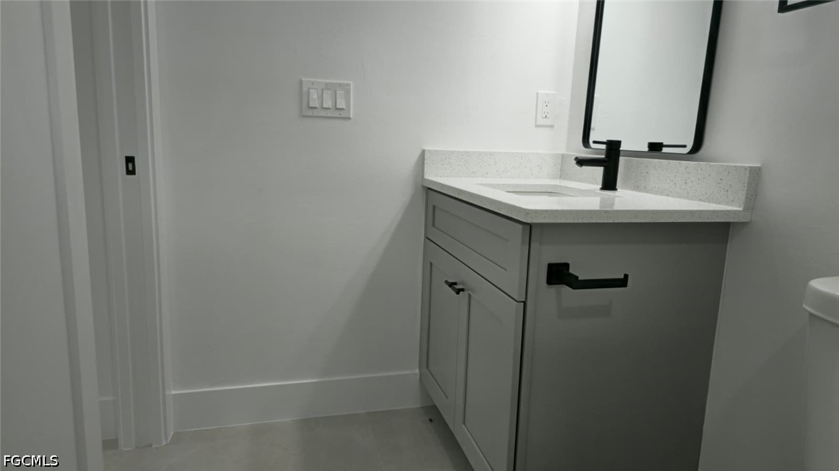 4429 26th Street Southwest Lehigh Acres, FL 33973 - Photo 14 of 16 a bathroom with a sink and a mirror