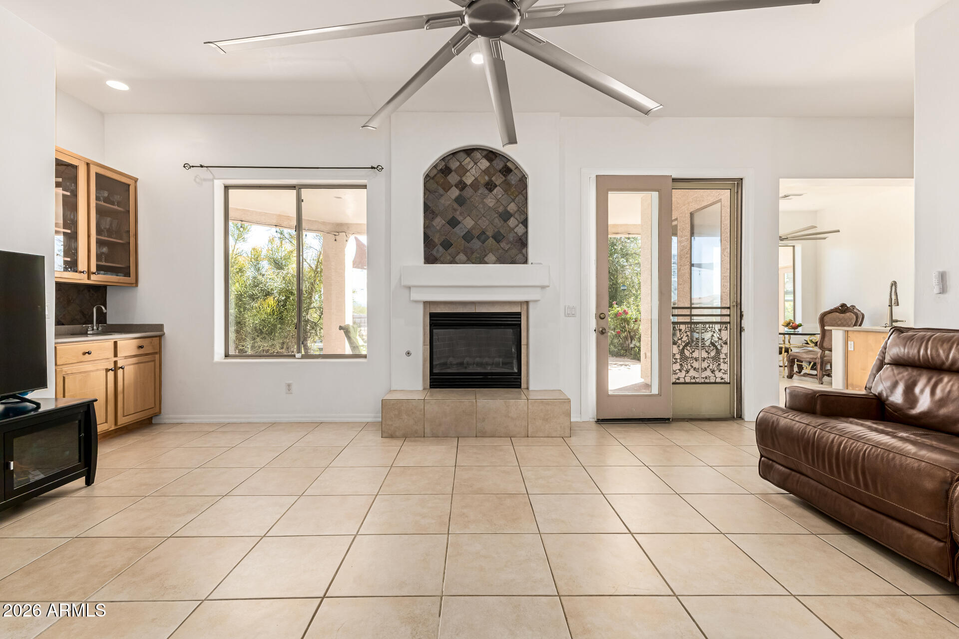 12607 West Ocotillo Road Glendale, AZ 85307 - Photo 11 of 52 a view of an empty room with a fireplace and a window