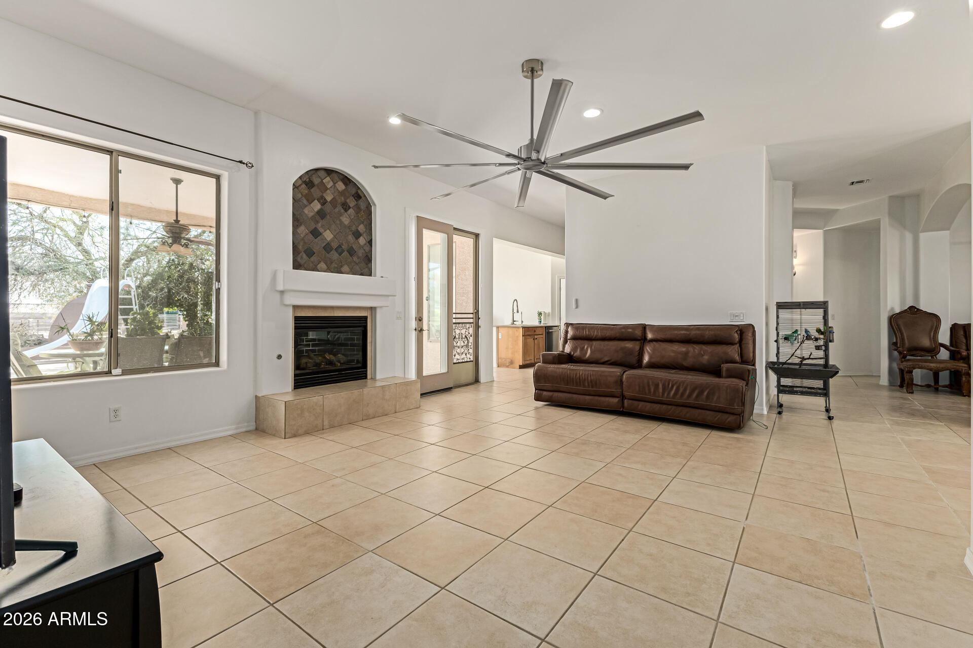 12607 West Ocotillo Road Glendale, AZ 85307 - Photo 12 of 52 a living room with furniture a fireplace and a large window