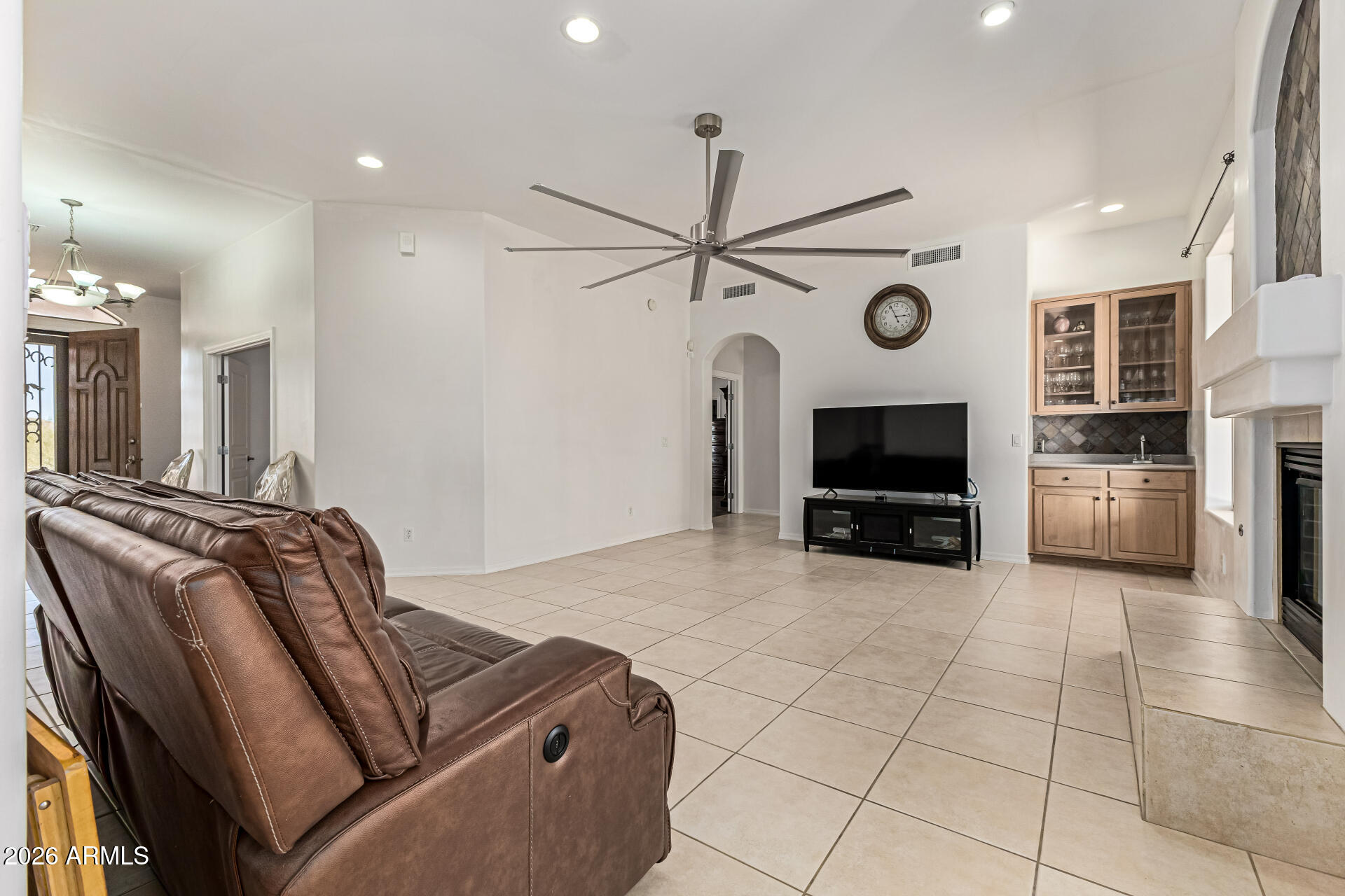 12607 West Ocotillo Road Glendale, AZ 85307 - Photo 14 of 52 a living room with furniture a flat screen tv and kitchen view