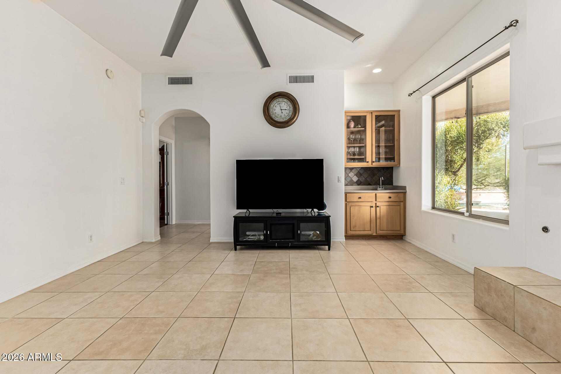 12607 West Ocotillo Road Glendale, AZ 85307 - Photo 15 of 52 a living room with furniture a flat screen tv and a fireplace