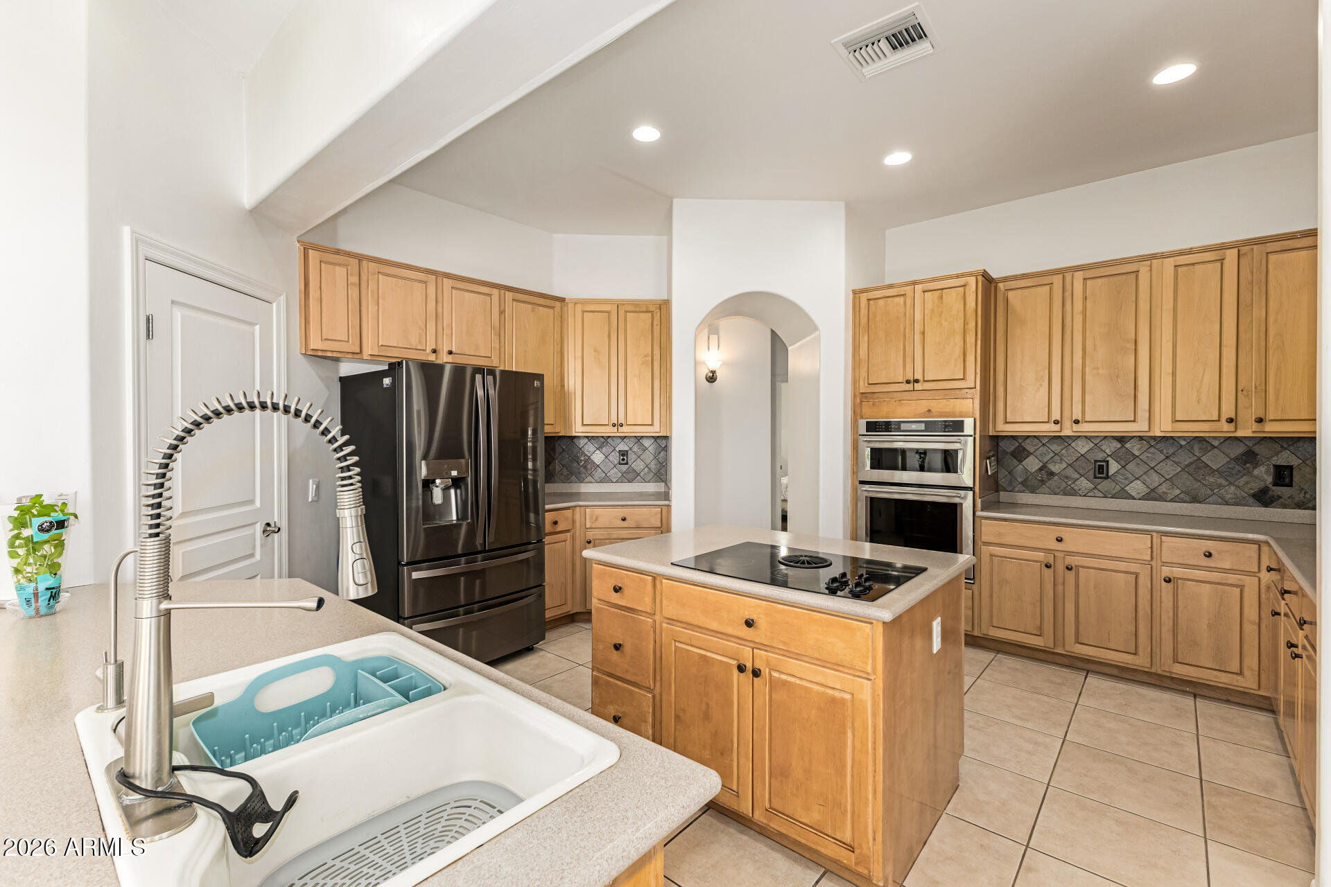 12607 West Ocotillo Road Glendale, AZ 85307 - Photo 19 of 52 a kitchen with stainless steel appliances granite countertop a refrigerator sink and stove
