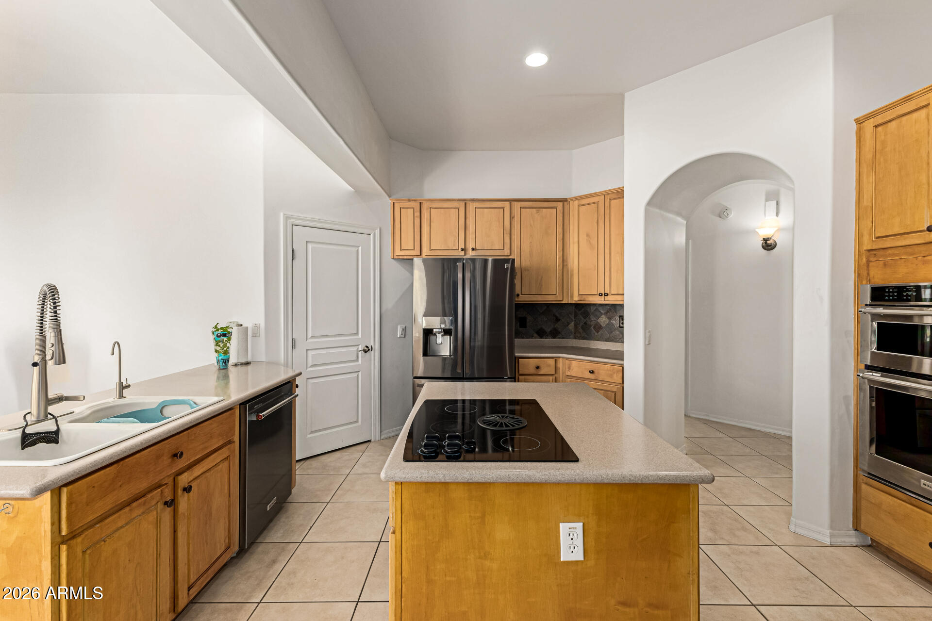 12607 West Ocotillo Road Glendale, AZ 85307 - Photo 20 of 52 a kitchen with sink a refrigerator and cabinets