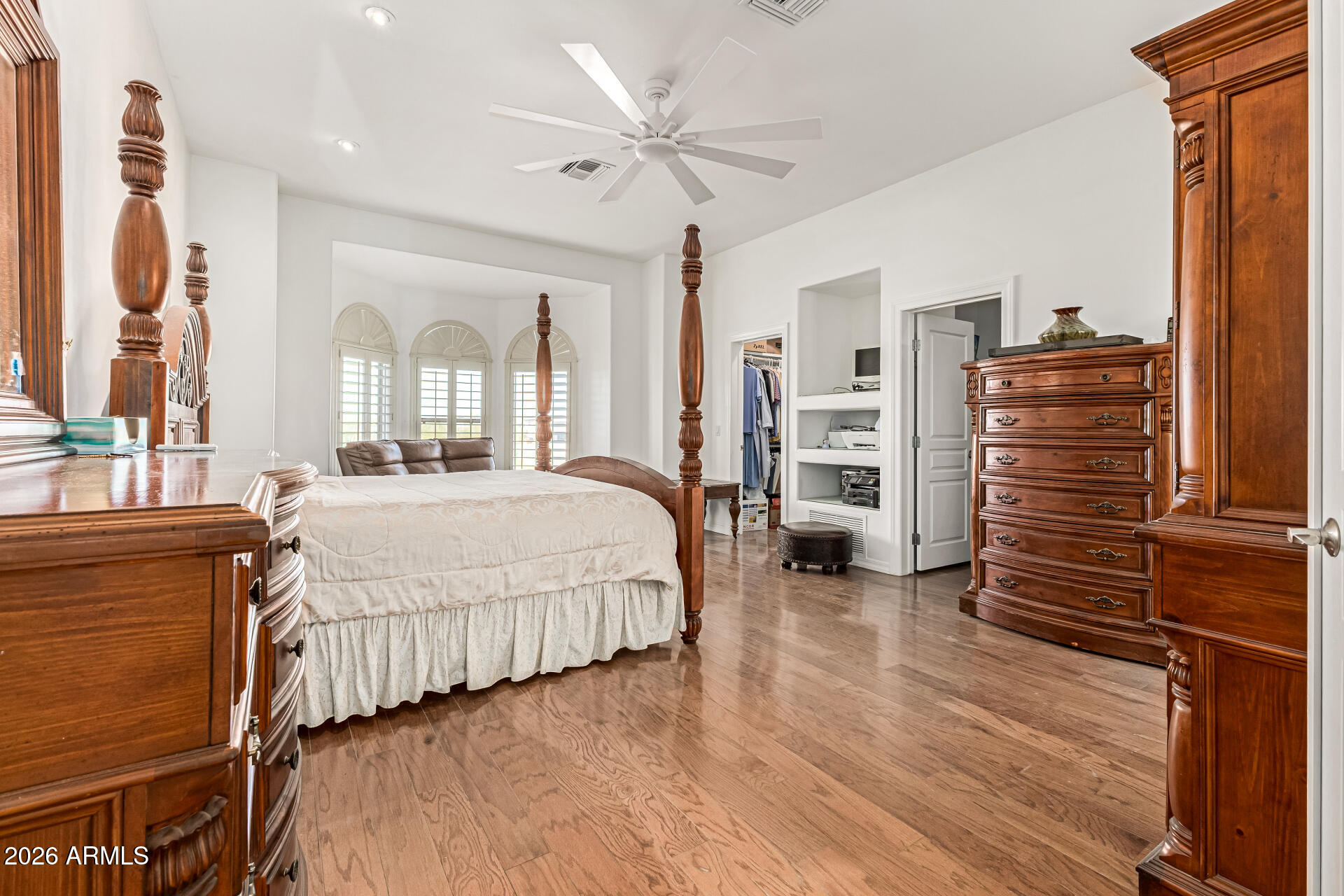 12607 West Ocotillo Road Glendale, AZ 85307 - Photo 23 of 52 a spacious bedroom with a bed and a ceiling fan