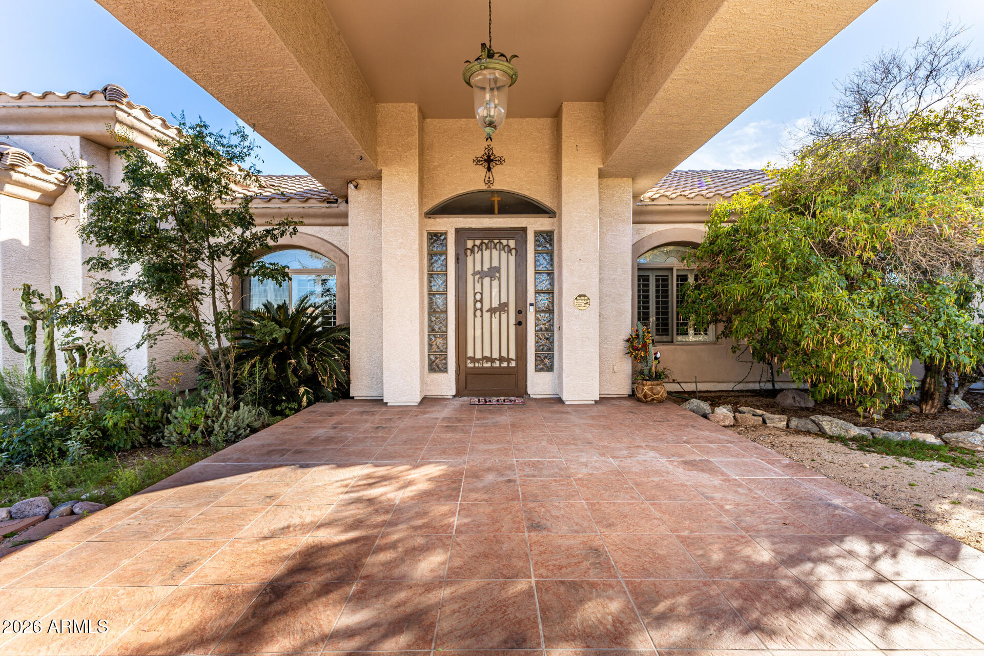 12607 West Ocotillo Road Glendale, AZ 85307 - Photo 7 of 52 a view of a house with brick walls and potted plants in front of main door