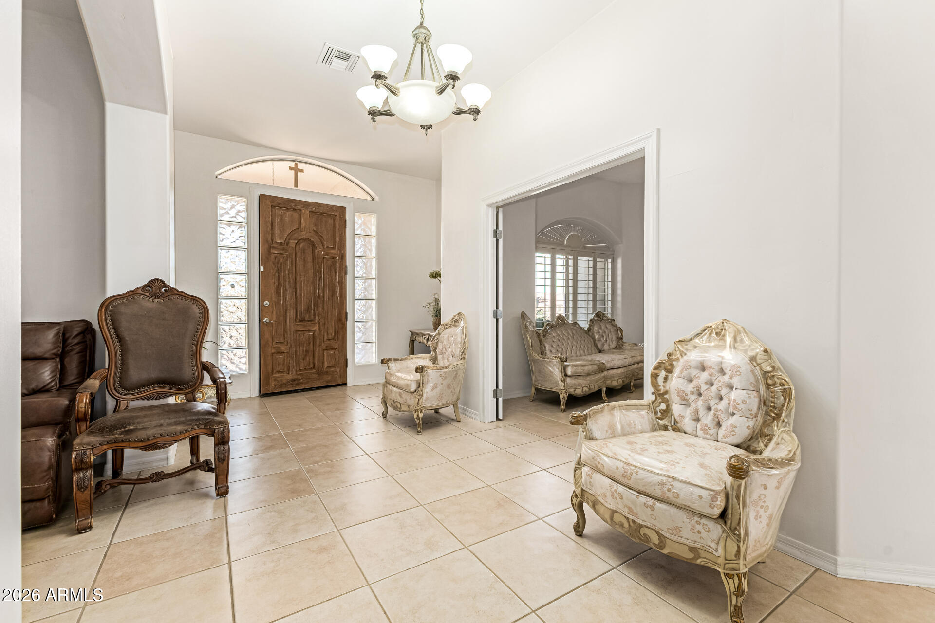 12607 West Ocotillo Road Glendale, AZ 85307 - Photo 8 of 52 a living room with furniture and a chandelier