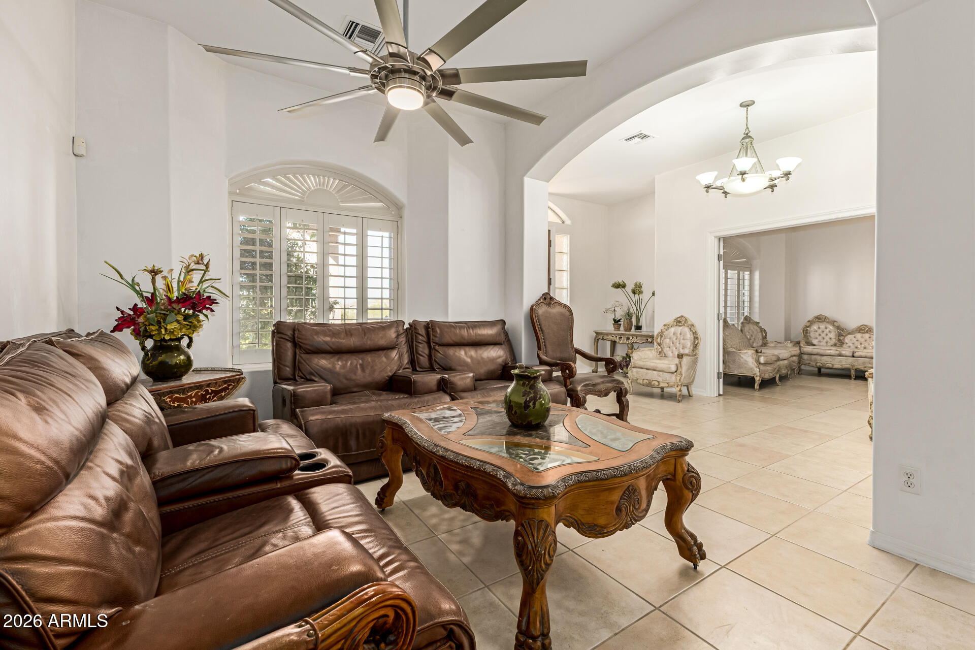 12607 West Ocotillo Road Glendale, AZ 85307 - Photo 9 of 52 a living room with furniture and a chandelier
