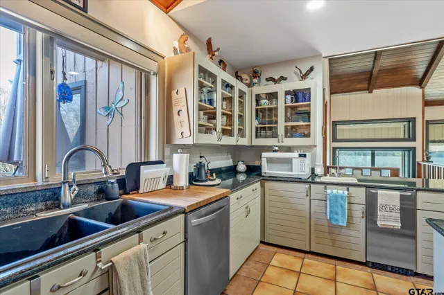 a kitchen with stainless steel appliances granite countertop a stove and a refrigerator