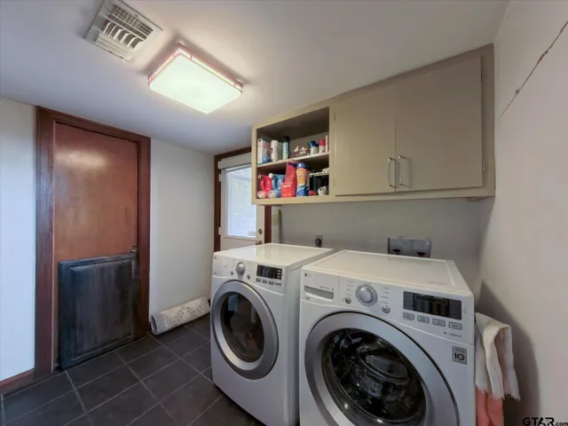 a hallway with a baby crib furniture and a chandelier