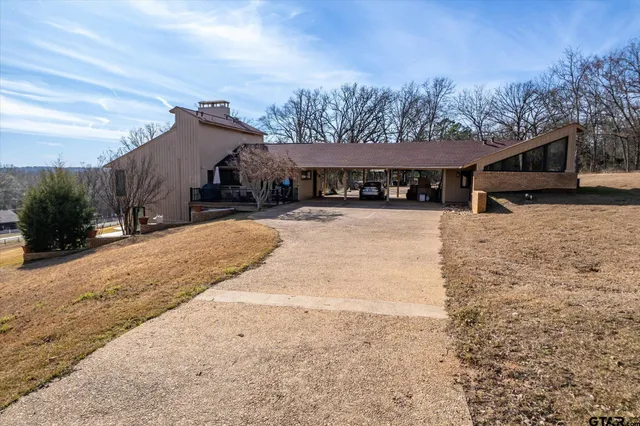 a view of a house with a yard covered in snow