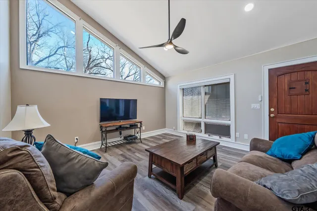 a bathroom with a granite countertop sink a mirror and shower