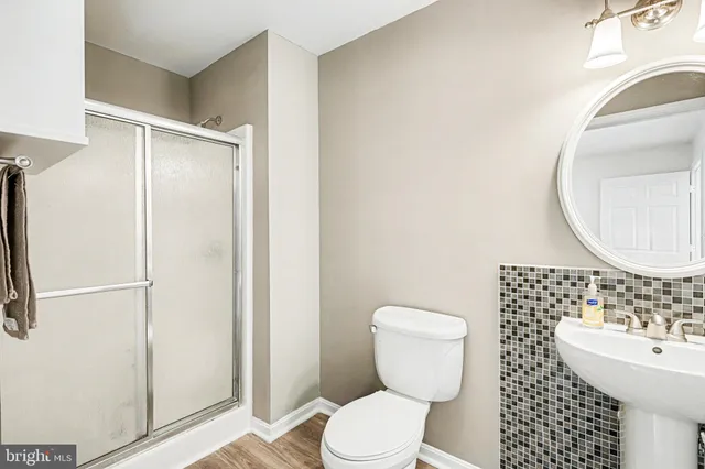 a bathroom with a toilet a sink and a mirror