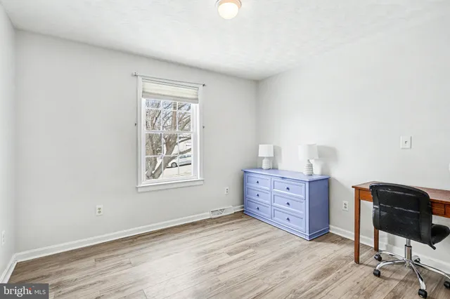 a room with dresser and window