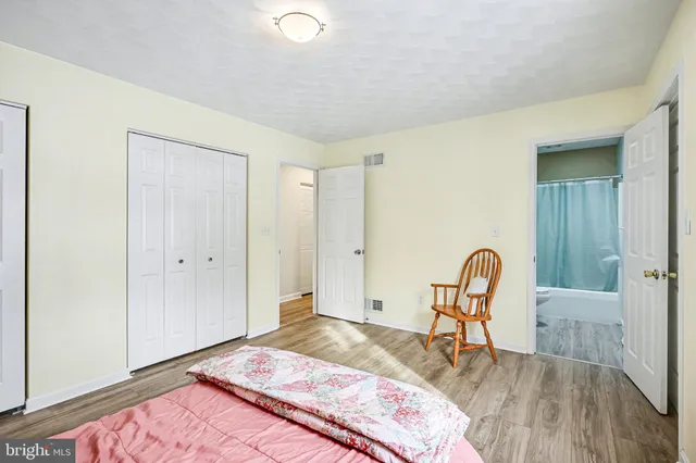 a bedroom with a bed and a dresser