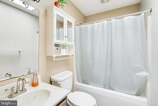 a white toilet sitting next to a bathroom sink