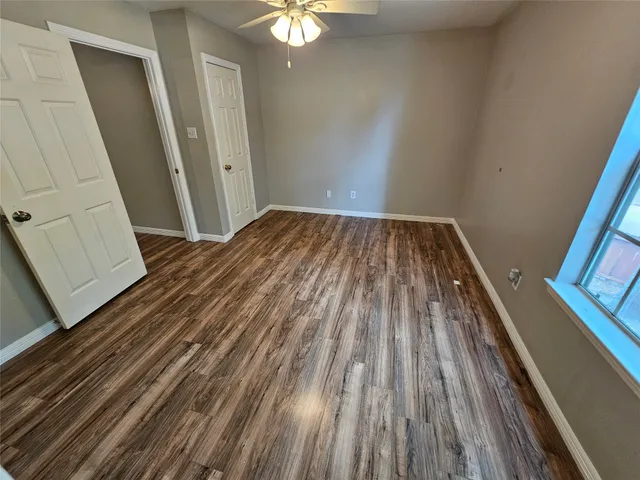 a view of a room with wooden floor and staircase
