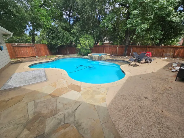 a view of a swimming pool with a patio