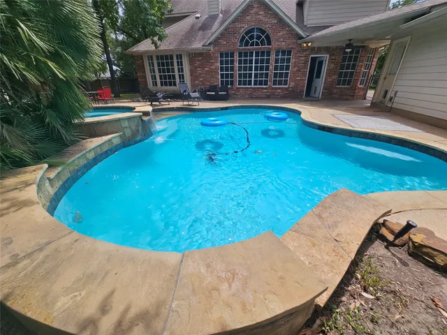 a view of swimming pool with outdoor seating and yard