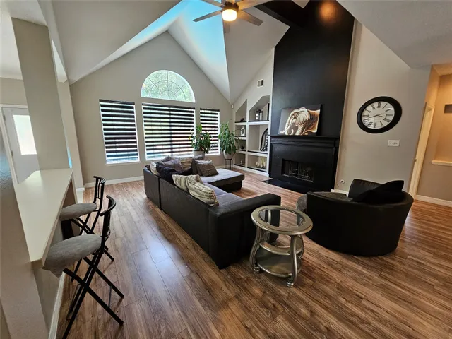 a living room with furniture and a wooden floor