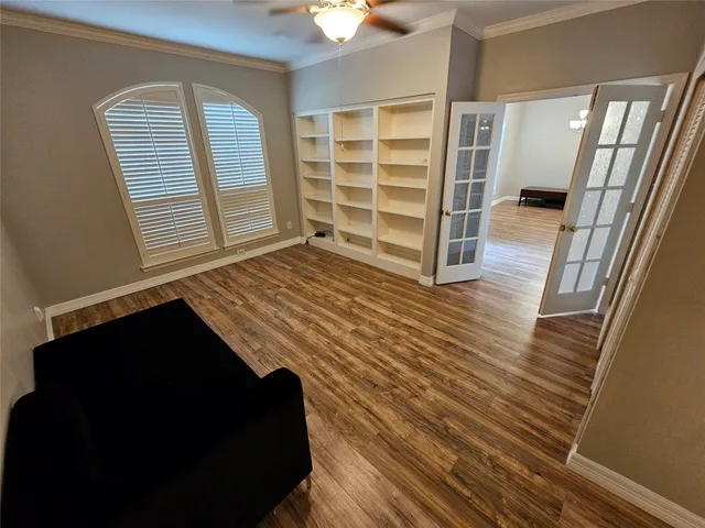 a view of bedroom with wooden floor and closet