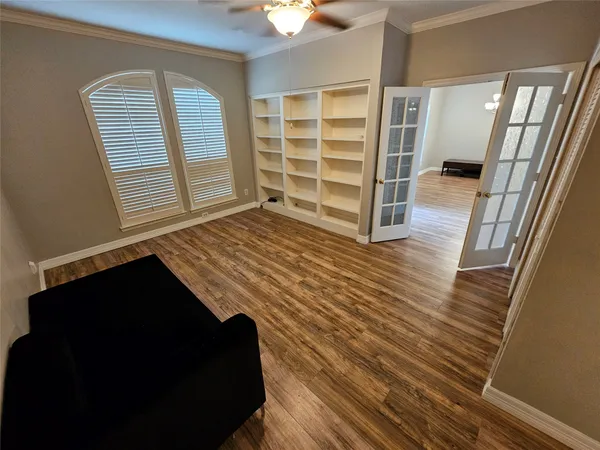 a view of bedroom with wooden floor and closet