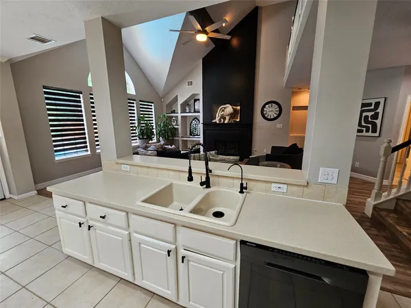 a kitchen with cabinets and window