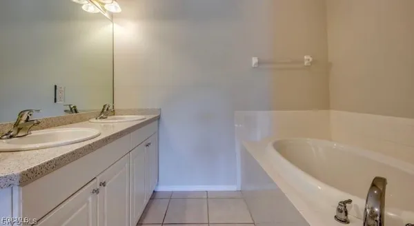 a bathroom with a granite countertop sink a toilet and bathtub