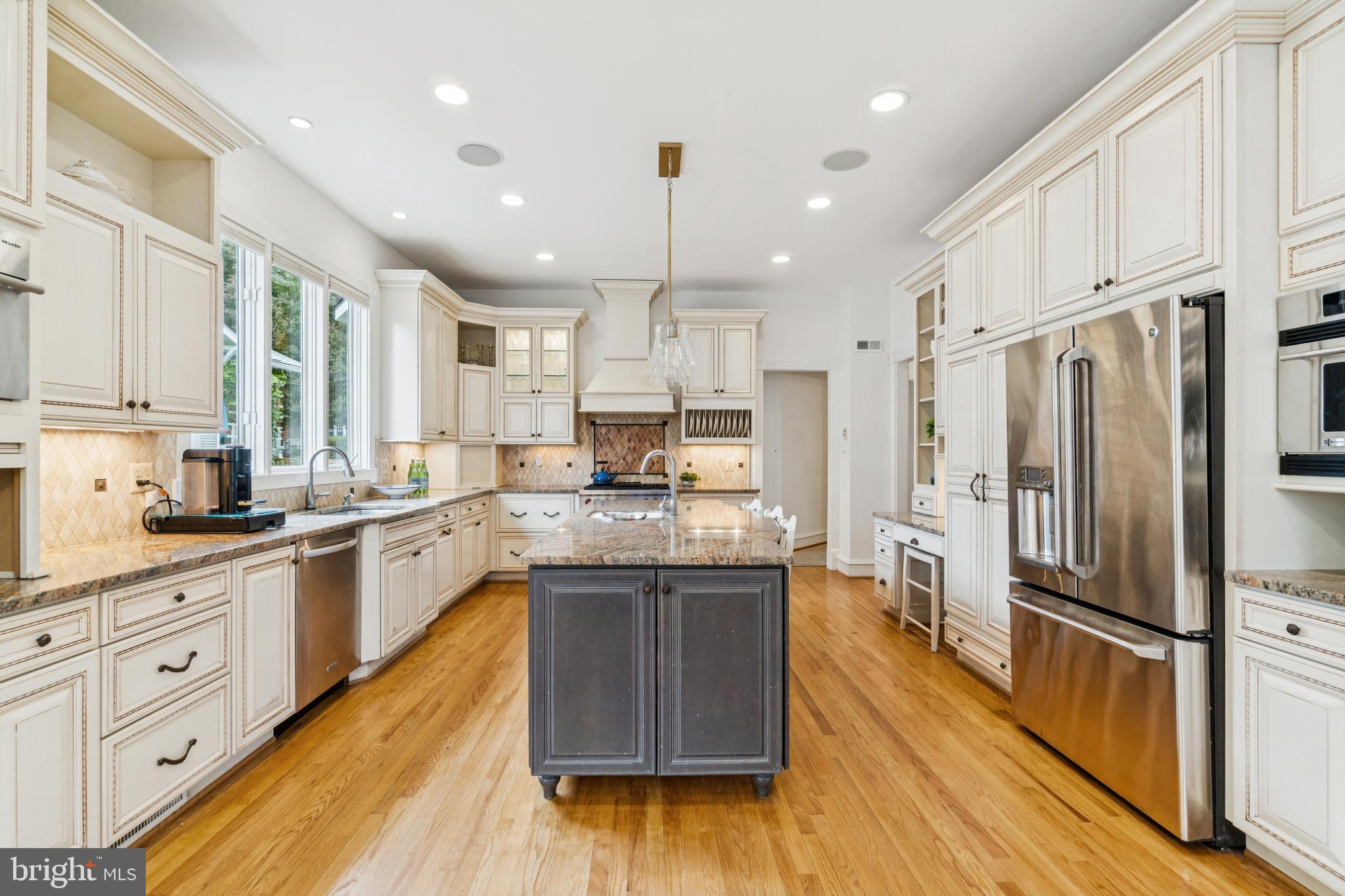 4406 Stanford Street Chevy Chase, MD 20815 - Photo 11 of 49 a kitchen with stainless steel appliances granite countertop a refrigerator a sink dishwasher a stove and white cabinets with wooden floor