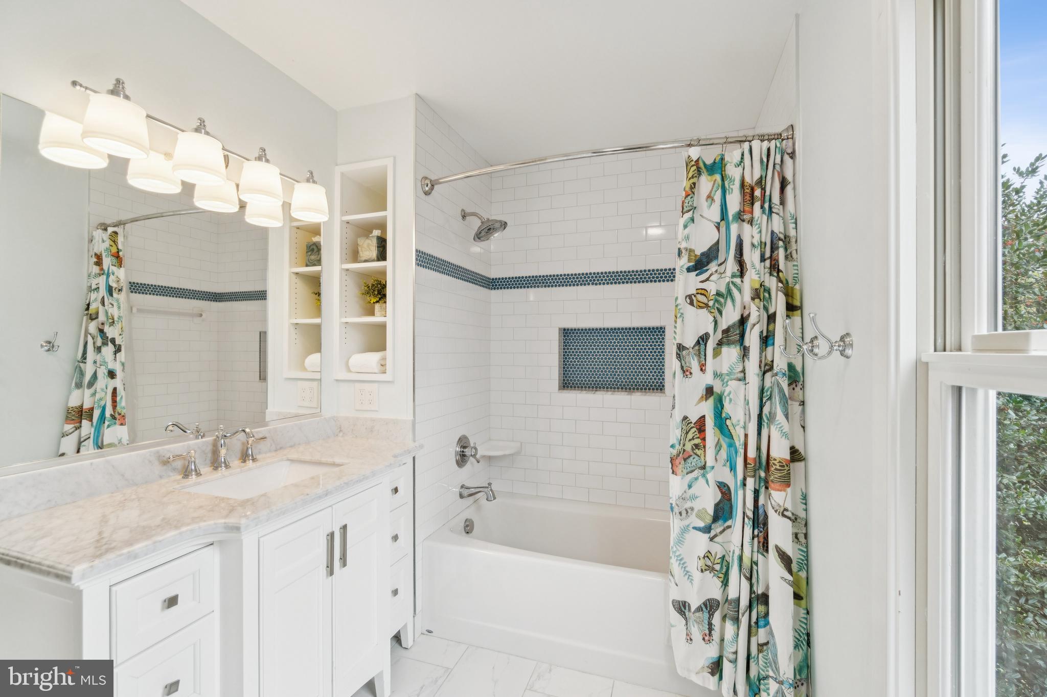4406 Stanford Street Chevy Chase, MD 20815 - Photo 35 of 49 a bathroom with a granite countertop sink a mirror a vanity and a shower