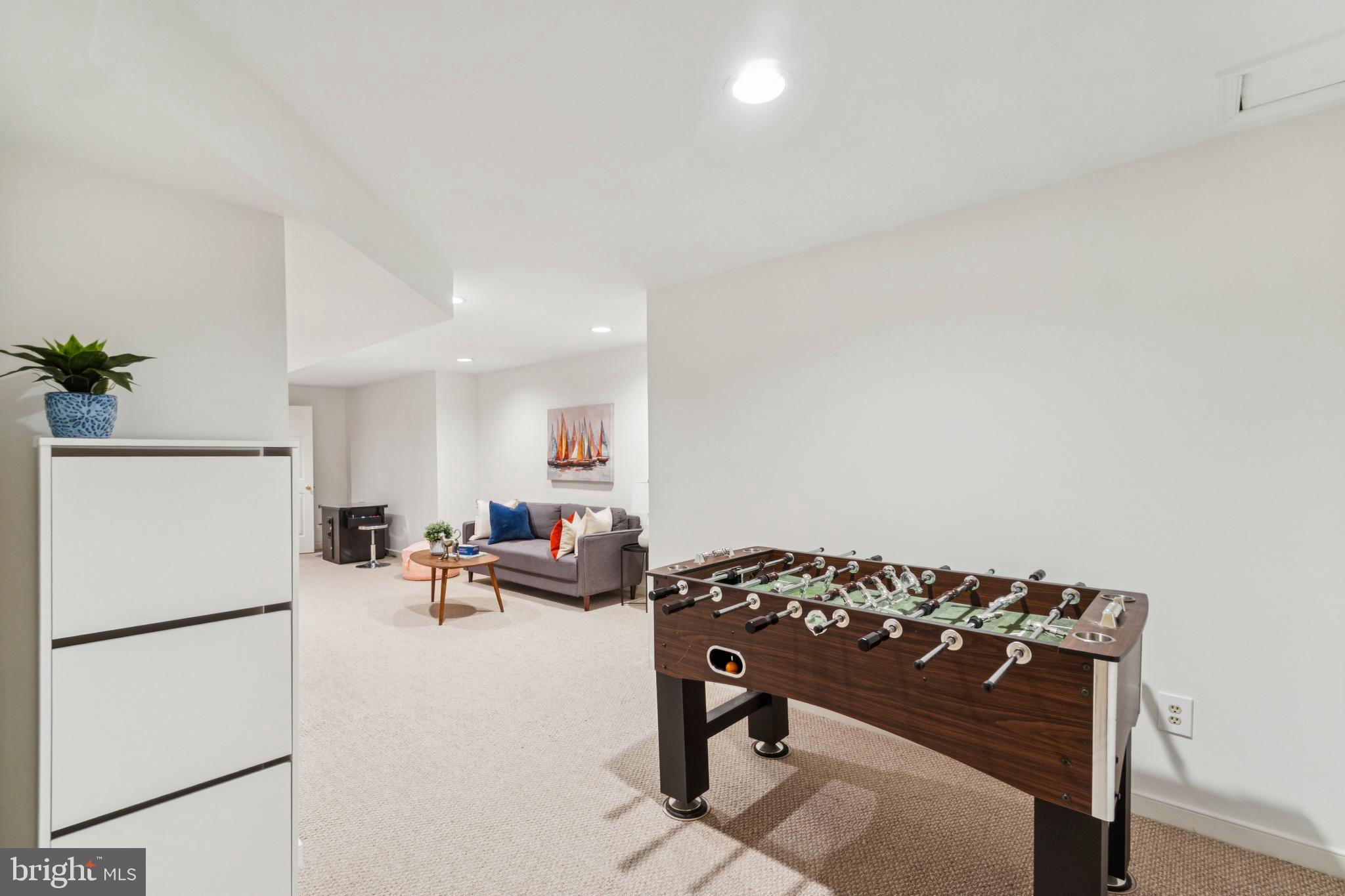 4406 Stanford Street Chevy Chase, MD 20815 - Photo 37 of 49 a living room with a couch and a refrigerator