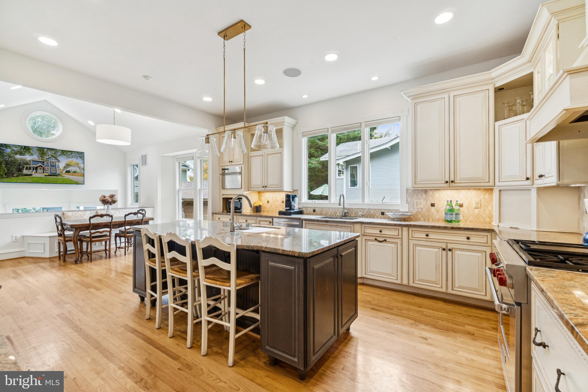 4406 Stanford Street Chevy Chase, MD 20815 - Photo 10 of 49 a large kitchen with cabinets a sink a counter and chairs in it