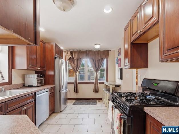 166 Summit Cross Rutherford, NJ 07070 - Photo 15 of 49 a kitchen with stainless steel appliances granite countertop a stove a sink dishwasher and a refrigerator