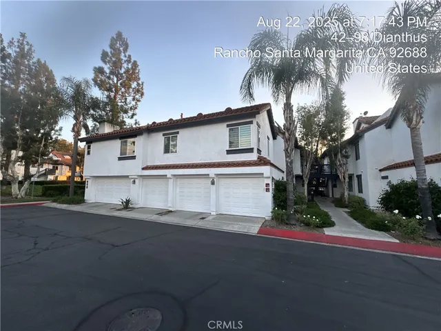 a white house with palm tree in front of it