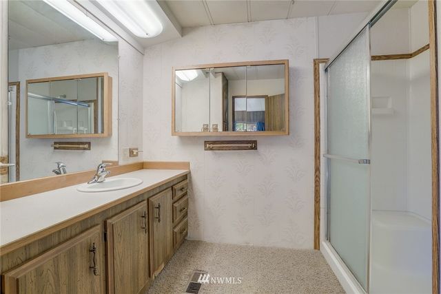 a bathroom with a granite countertop sink and a mirror