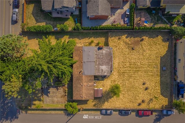 an aerial view of residential houses with outdoor space and swimming pool