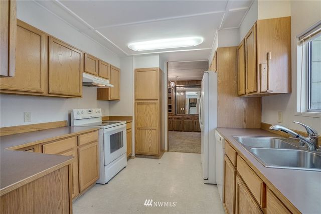 a kitchen with a sink cabinets and stainless steel appliances
