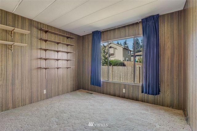 an empty room with windows and closet