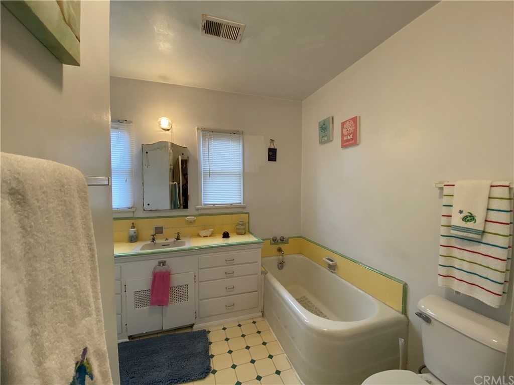 130 Pacific Street Bakersfield, CA 93305 - Photo 12 of 25 a bathroom with a tub sink and mirror