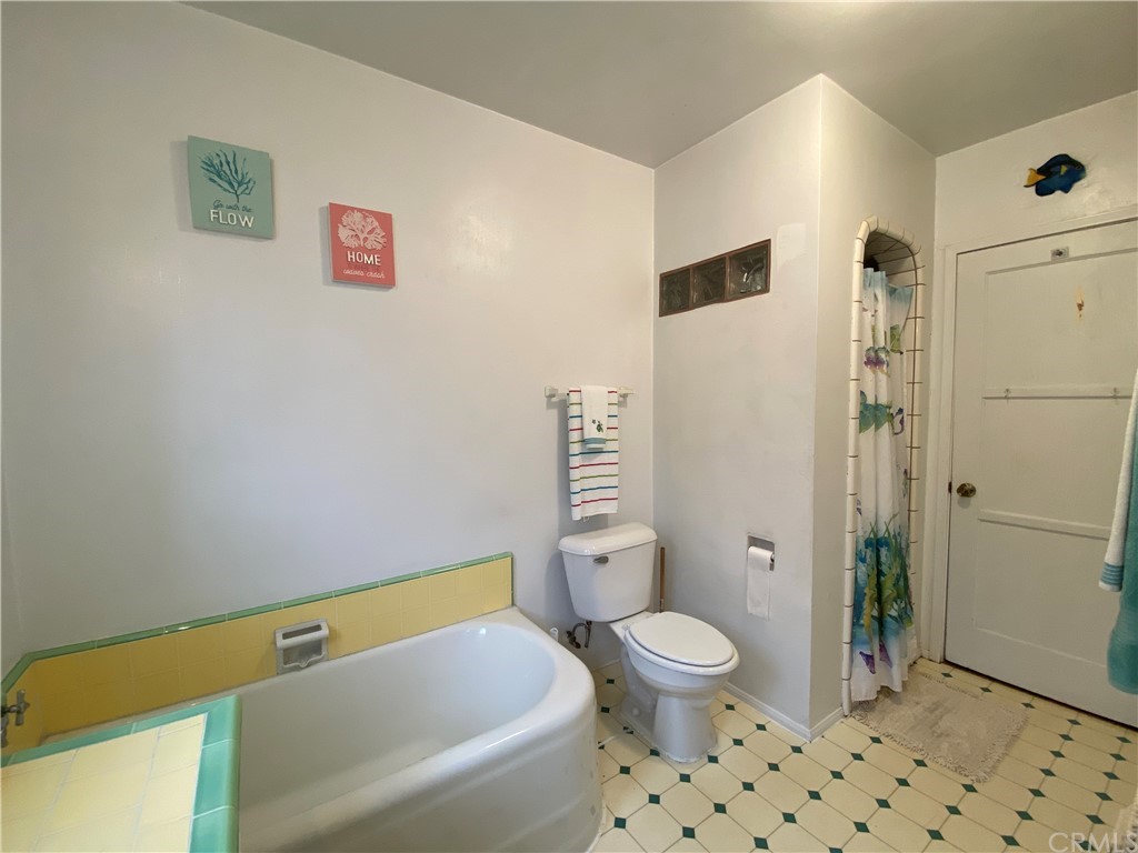 130 Pacific Street Bakersfield, CA 93305 - Photo 13 of 25 a bathroom with a toilet and a shower