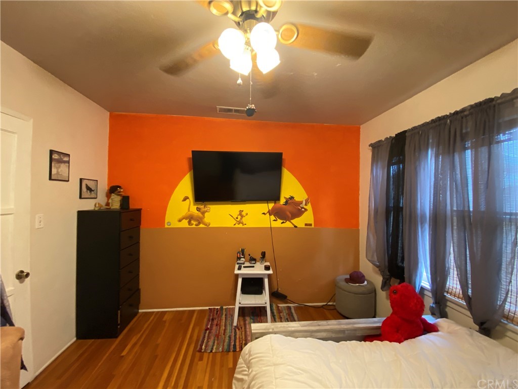 130 Pacific Street Bakersfield, CA 93305 - Photo 14 of 25 a bedroom with a bed and a flat screen tv