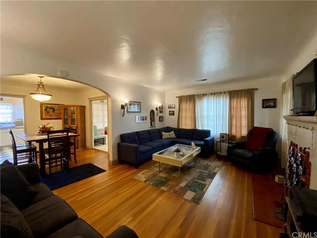 130 Pacific Street Bakersfield, CA 93305 - Photo 3 of 25 a living room with furniture fireplace and a flat screen tv