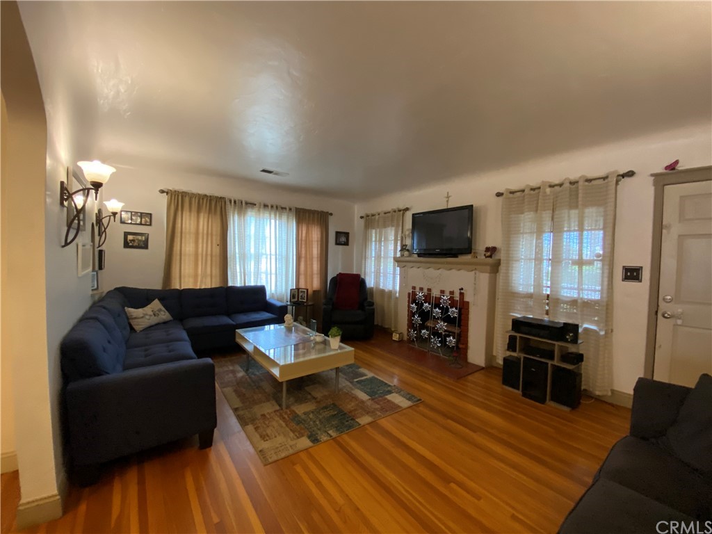 130 Pacific Street Bakersfield, CA 93305 - Photo 4 of 25 a living room with furniture and a flat screen tv
