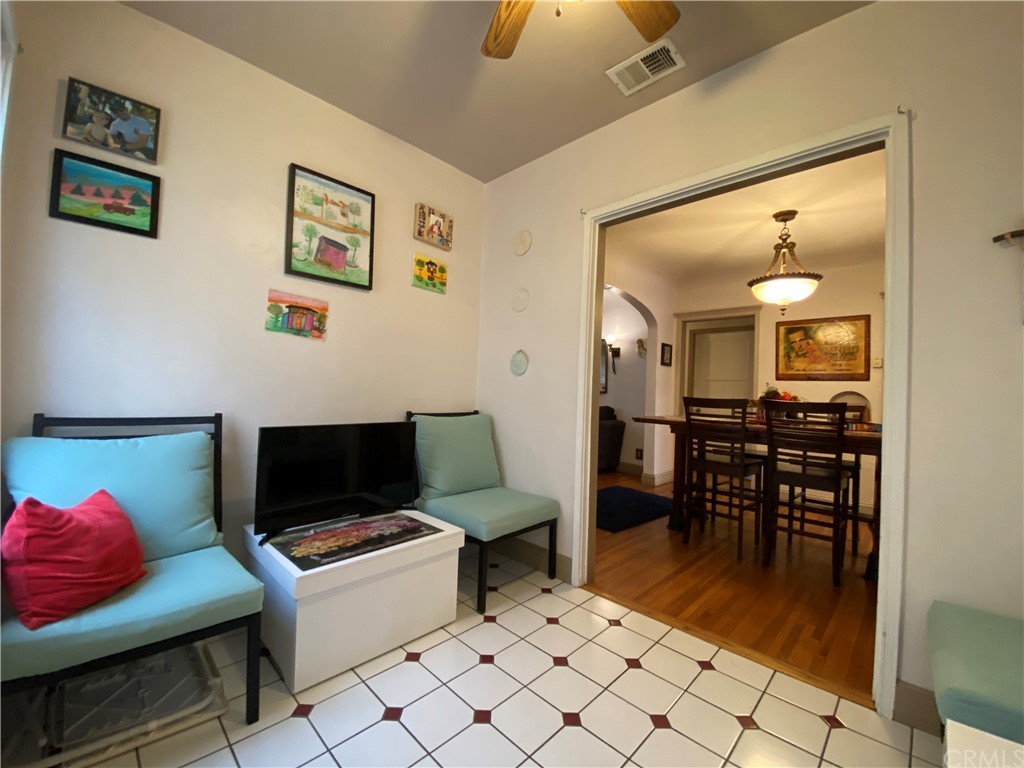 130 Pacific Street Bakersfield, CA 93305 - Photo 7 of 25 a living room with furniture and a dining table with wooden floor