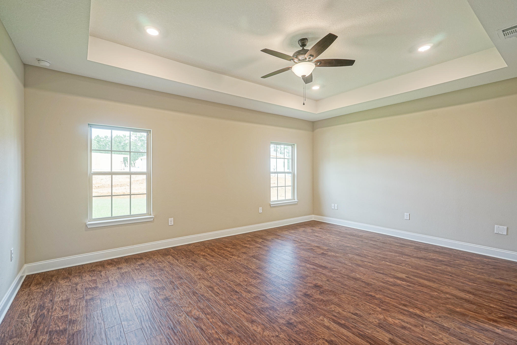 6193 Timberland Ridge Drive Crestview, FL 32539 - Photo 13 of 37 a view of an empty room with a window and wooden floor