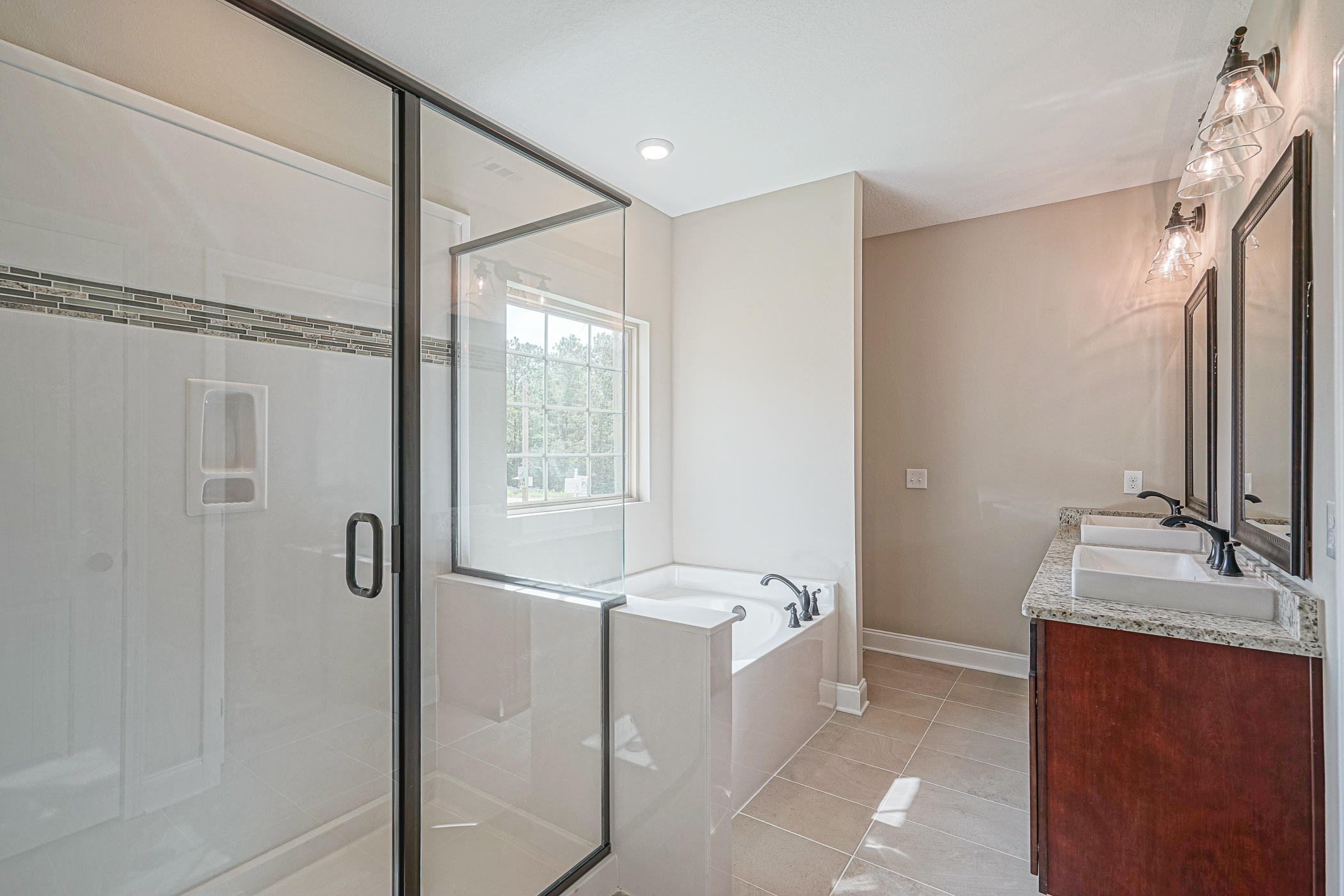 6193 Timberland Ridge Drive Crestview, FL 32539 - Photo 15 of 37 a bathroom with a tub sink and mirror
